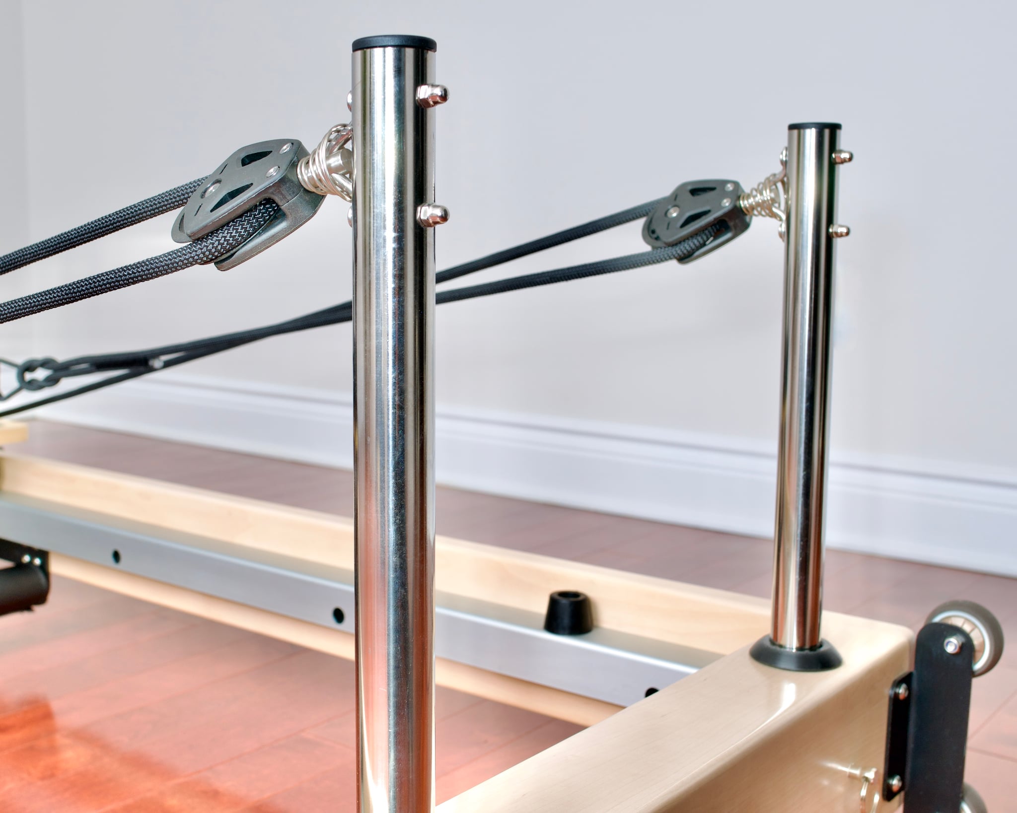 Closeup of the rear posts and pulleys for a Maple Elite Home Folding Reformer.