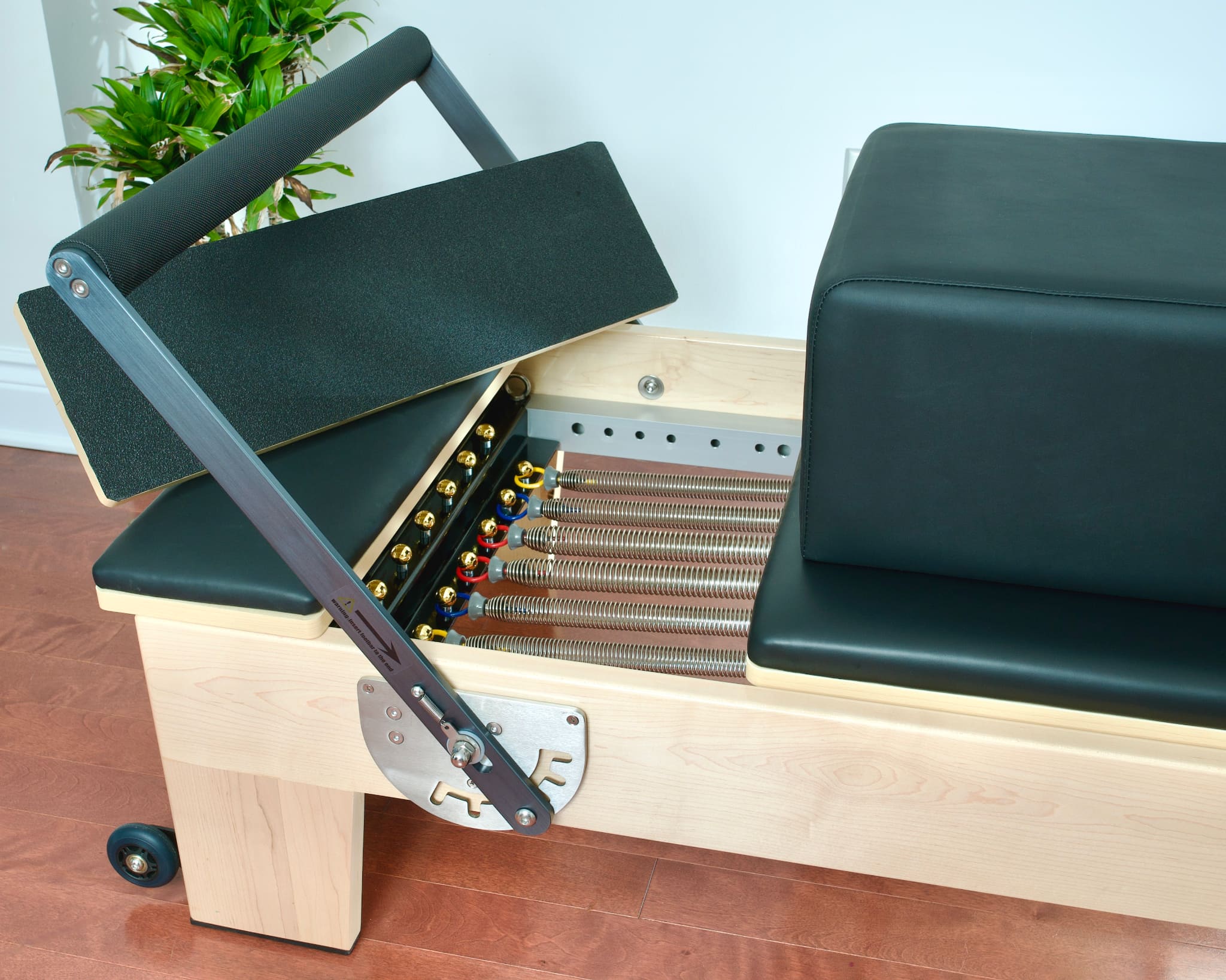 Top angled view showing the sitting box, platform extenders, and footbar of the Maple Elite Studio Reformer With Tower.